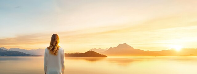 Canvas Print -  Woman before lake, mountains backdrop, sun sinking behind