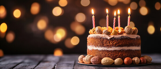 A delicious birthday cake with candles, surrounded by festive lights, perfect for celebrations and joyful occasions.