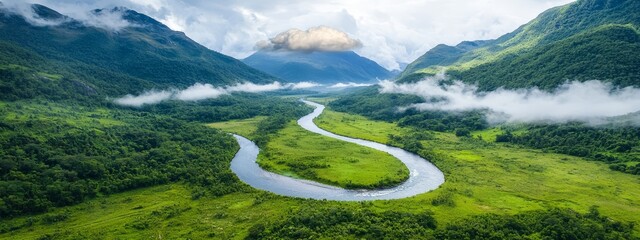 Wall Mural -  A bird's-eye perspective of a serene river winding through a verdant valley, framed by distant mountain ranges