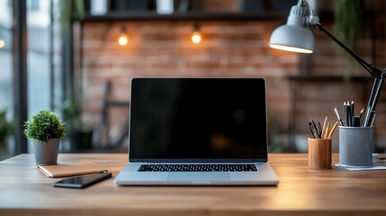 Blank screen laptop computer on a wooden desk in a modern office setting at night