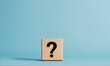 © Dmitriy - Question mark on wooden block against blue background
