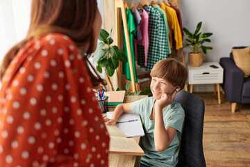 Wall Mural - A mother shares a delightful time with her hearing impaired son, fostering connection.