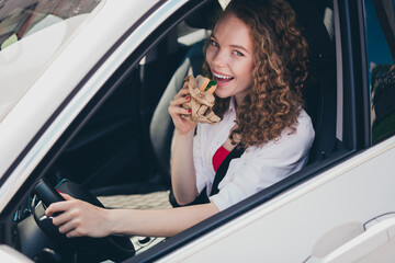 Poster - Photo of charming positive woman wear white shirt driving auto going vacation enjoying sandwich outdoors urban city street