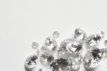 Poster - Many beautiful shiny diamonds on white background, flat lay. Space for text