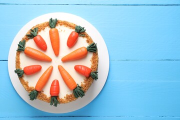 Wall Mural - Delicious carrot cake on light blue wooden table, top view. Space for text