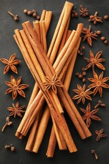 Wall Mural - Aromatic cinnamon sticks star anise on dark background