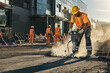 © TAMER YILMAZ - A labourer working on road construction with an air hammer.