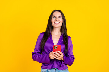 Sticker - Photo of positive smiling lady hold use cellphone look up empty space isolated bright color background