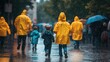 © 69 - Back view of adults and kids wearing bright yellow raincoats, strolling in the pouring rain on a wet street.