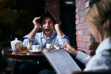 Happy business people working together on laptop in a restaurant