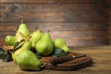 Poster - Fresh green pears, leaves and knife on wooden table, closeup. Space for text