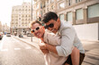 © ADDICTIVE STOCK - Joyful multiethnic gay couple having fun on a sunny urban street