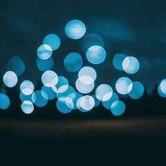 Wall Mural - Blue bokeh on dark background for celebration