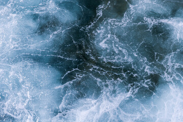 Wall Mural - stormy sea water surface, top view. abstract background photo