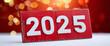 © Anna - number 2025 written on red wooden signboard