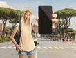 © Ljupco Smokovski - Female backpacker holding a smartphone on a street in Rome