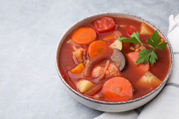 Poster - Delicious homemade stew in bowl on light table, closeup