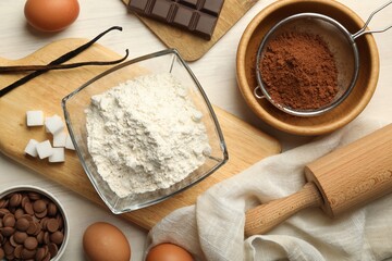 Wall Mural - Flat lay composition with flour, eggs and other ingredients for making dough on light table