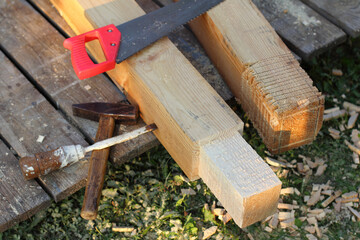 wooden beams for construction and tools on a pallet in the yard. break in carpentry