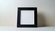 © Daniel - A sleek, minimalist black picture frame with a white mat board stands isolated on a pure white background, awaiting a cherished photograph or artwork.