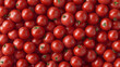 © Oksana - A seamless background of many ripe red tomatoes with a glossy surface, gathered together