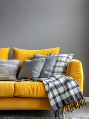 A living room with a gray wall finish. A close-up picture of a modern minimalist interior living room with a yellow sofa and a gray cushion and blanket. Generative AI