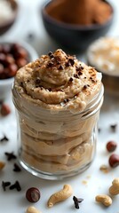 A delectable jar of layered dessert with whipped cream, chocolate shavings, and nuts, perfect for food photography, dessert menus, or culinary blogs showcasing indulgent treats.