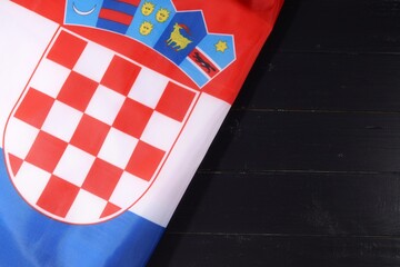 Croatian flag featuring a traditional coat of arms displayed on a wooden surface during a cultural event in Croatia