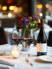 Elegant dining table with wine glasses, a bottle of red wine, and a floral centerpiece during an evening at a fine restaurant