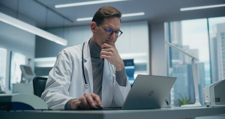 Aufkleber - Male Doctor in a High-tech Hospital Office Works on a Laptop, Analyzing Medical Data. the Modern Clinical Environment Highlights Advanced Healthcare, Research.
