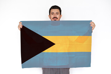 Young man holding Bahamas flag, independence day idea, two hands and white background, protest 