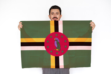 Young man holding Dominica flag, independence day idea, two hands and white background, protest 