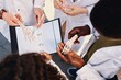 © Seventyfour - Top view of foot skeleton model in hands of African American medical student examining bones while standing in circle with classmates outdoors, copy space