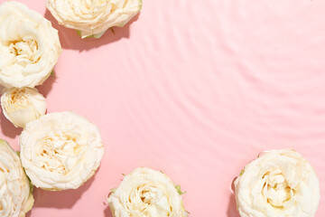 Poster - Beautiful rose flowers in water on pink background, top view. Space for text