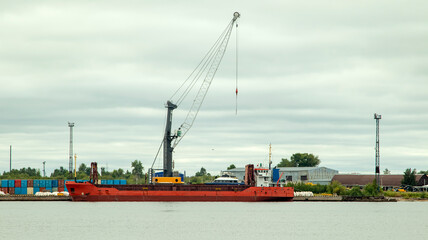 A large cargo sea vessel is at anchor, a dry cargo ship is at anchor