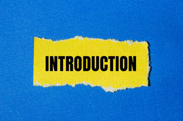 Introduction message written on ripped yellow torn paper piece with blue background. Conceptual introduction symbol. Copy space.