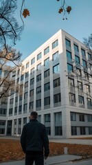 Canvas Print - Man in Black Jacket Looking at Modern Building