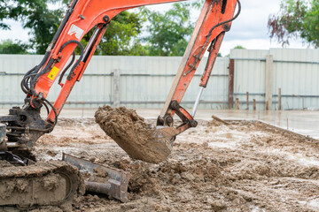 Mini excavator shoveling soil.