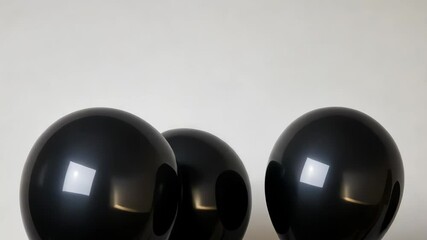 Wall Mural - Three black balloons floating against a white background