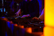© Yelena - DJ playing music at the nightclub. Close-up of male hands mixing music on midi controller