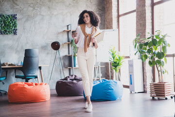 Poster - Portrait of elegant corporate worker lady hold coffee papers wear white shirt business center indoors