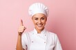 © Aqsapics - Young female chef in white uniform pointing finger up side