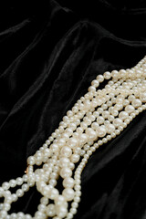 Vintage pearls, long pearl necklace, sotoire. Pearl necklace on a black background. place for text