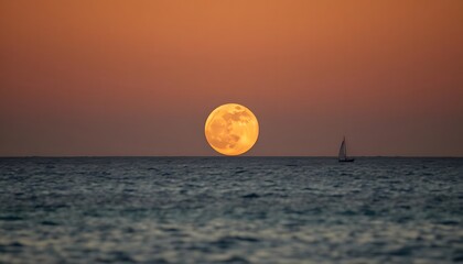 Wall Mural - A full moon rising over a dark ocean at sunset, with an orange and red sky in the background