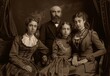 © MD Media - old photo of family, in the victorian style, father mother and two daughters, black background, sepia tone. style of 19th century style, vintage retro style Sepia-Toned Vintage Family Portrait