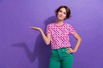 Poster - Photo of lovely sweet dreamy cute girl wear pink trendy clothes looking empty space demonstrate offer isolated on purple color background