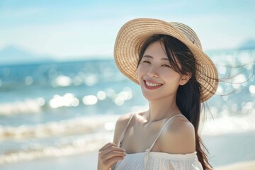 Wall Mural - A woman relaxes on the beach wearing a straw hat, enjoying the sun and sea