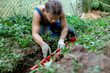 © velimir - A male plumber installs a sewer pipe in the yard of a house.