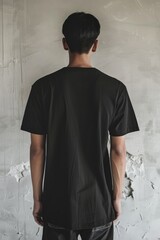 Poster - A person standing near a wall, wearing a black shirt