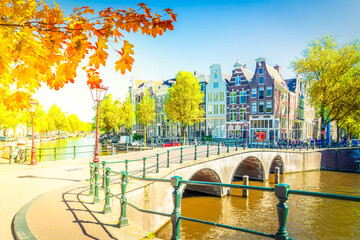 Canvas Print - houses of Amsterdam Netherlands over canal ring landmark in old european city, Amsterdam fall scenery